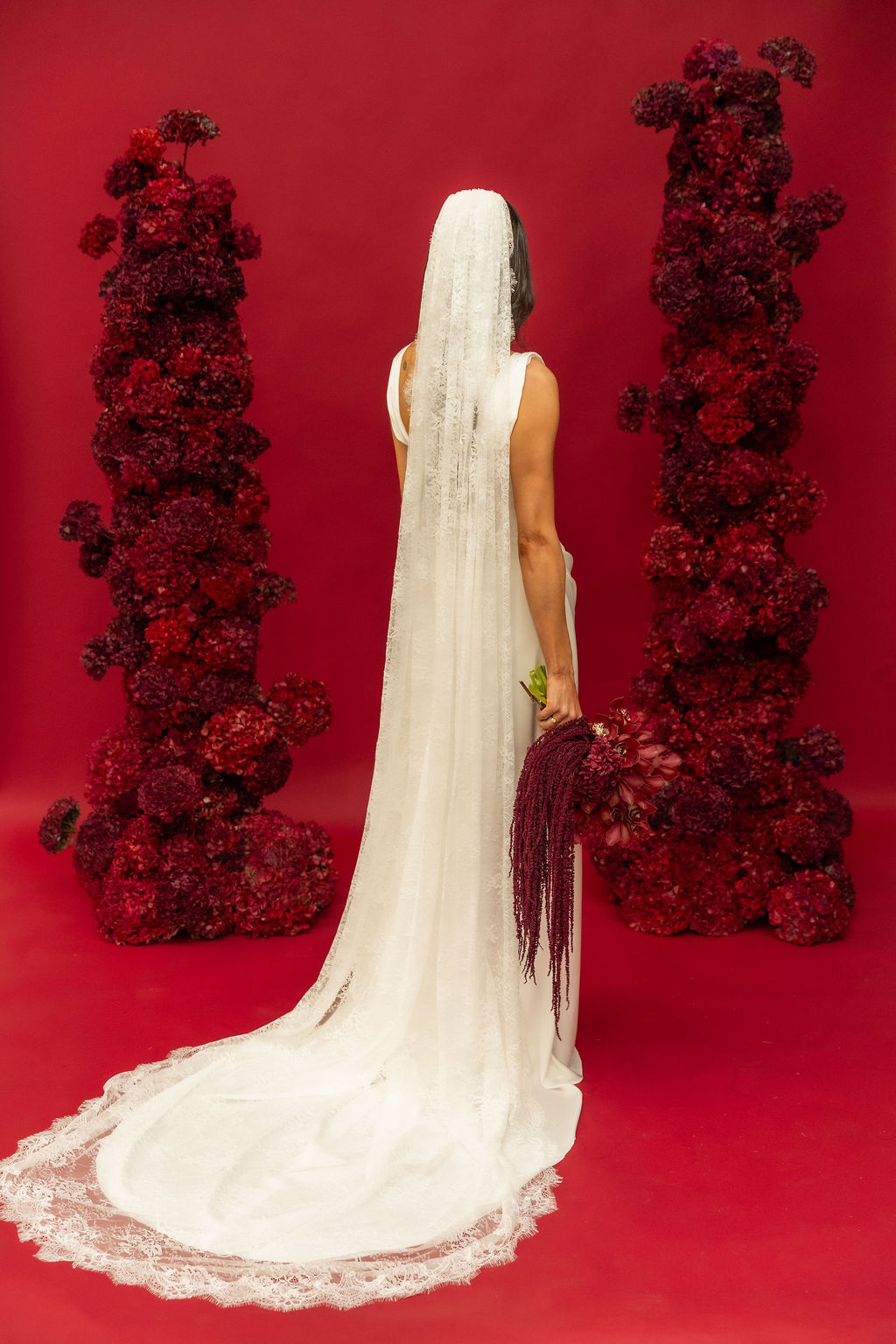 Back view of a chantilly lace veil falling the full length of a column wedding gown, from the FOUNDATION by Sarah Stoute shoot