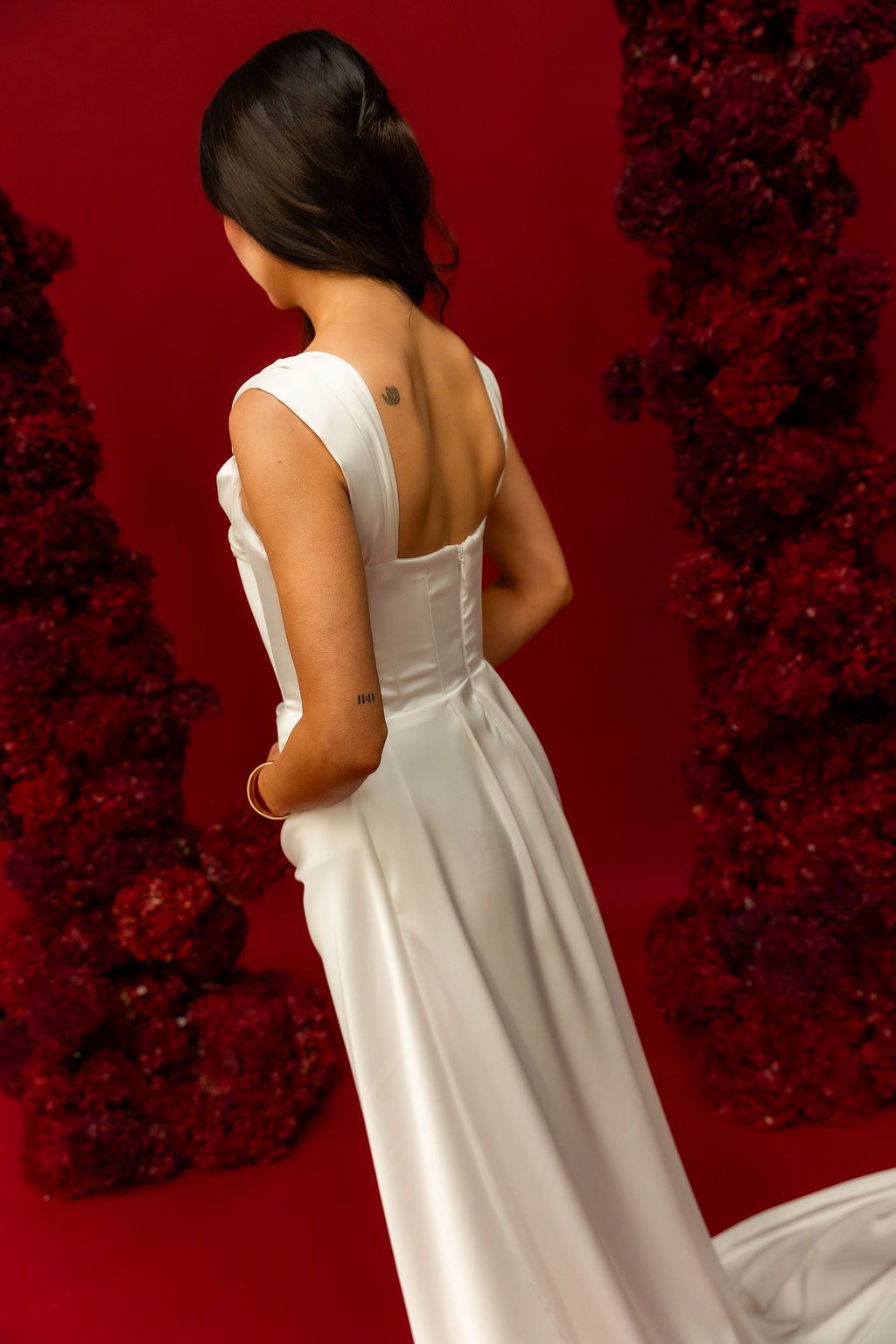 Back detail of a satin wedding gown falling in one smooth unbroken line, from the FOUNDATION by Sarah Stoute shoot